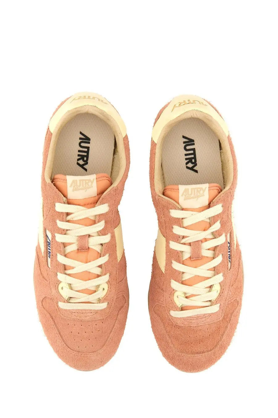 Autry women’s windspin low sneaker in peach suede with cream laces and matching accents featuring autry insole