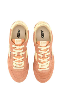 Autry women’s windspin low sneaker in peach suede with cream laces and matching accents featuring autry insole