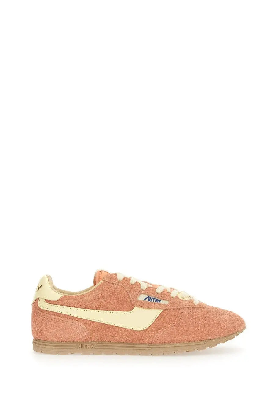Autry women’s windspin low sneaker in peach suede with cream midsole and matching lace up featuring autra logo