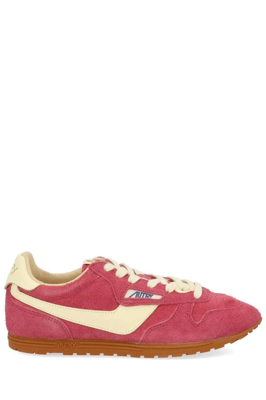 Autry women’s windspin low sneaker in pink suede with cream accents and tan rubber sole featuring autry logo