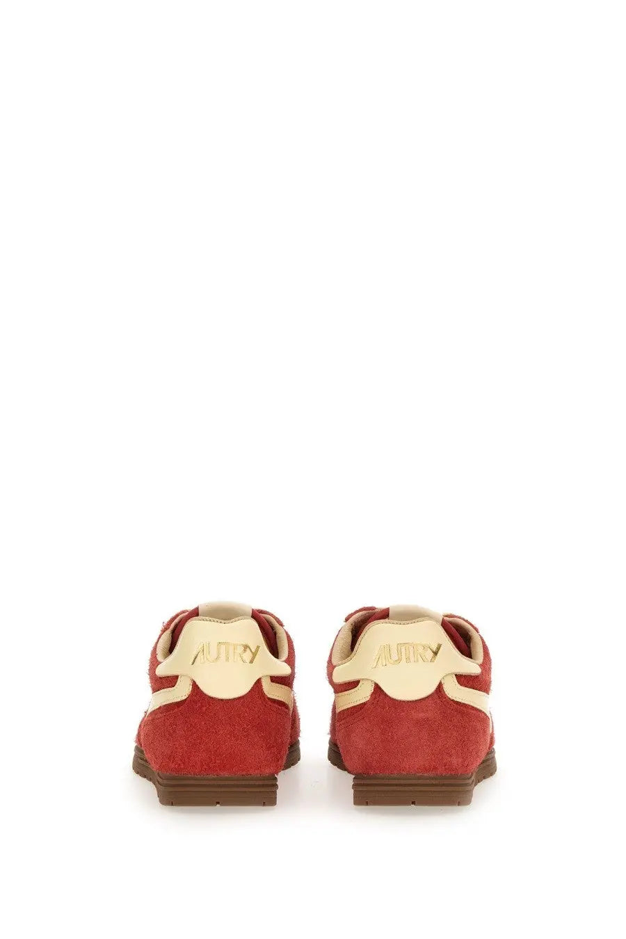 Back view of autry women’s windspin low sneaker in red suede with cream accents and brown rubber sole showing brand name
