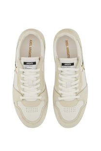 Cream-colored axel arigato men’s says lo bee bird sneaker with white laces and subtle gold branding details