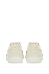 Cream-colored suede axel arigato men’s says lo bee bird sneaker with gold-tone heel branding and white rubber soles back view