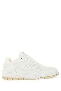 Axel arigato men’s white leather sneaker with subtle gold branding and beige rubber sole