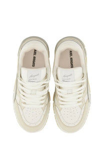 Cream-colored axel arigato women’s sneaker lo area white with chunky sole and perforated toe box