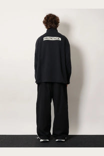Balenciaga men’s black cotton sweatshirt shown from the back with white embroidered logo on the jacket