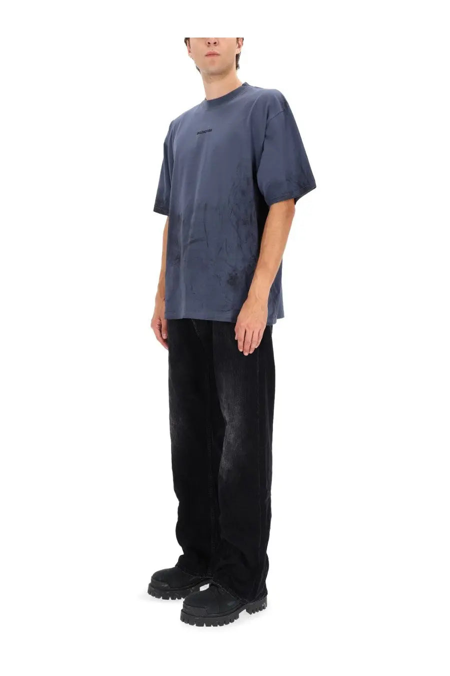 Balenciaga men’s deconstructed jeans black paired with a dark blue slightly faded textured cotton t-shirt with small black logo