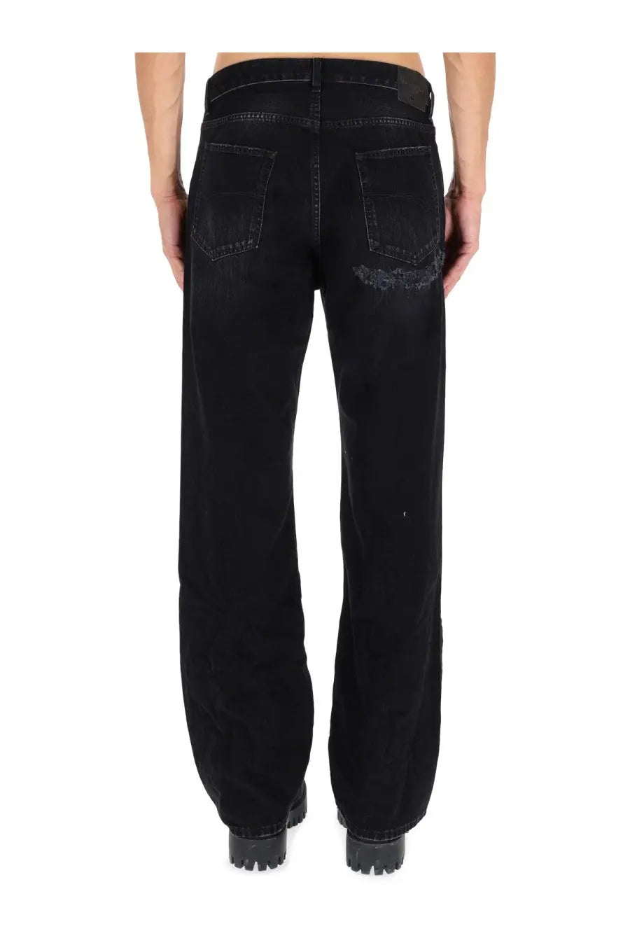 Balenciaga men’s deconstructed black denim jeans back side showing a distressed patch on the right rear pocket