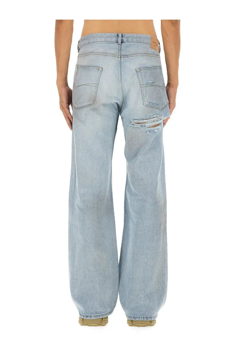 Balenciaga men’s light-wash denim deconstructed jeans with distressed ripped detail on the right thigh blue