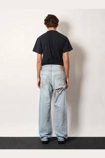 Balenciaga men’s light-wash denim jeans with distressed ripped knee detail in blue