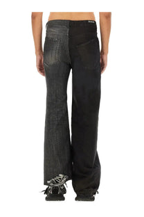 Back view of balenciaga men’s black denim fifty fifty jeans with split back design and distressed frayed hem