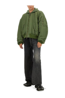 Olive green bomber jacket with hood and multiple pockets paired with balenciaga men’s fifty fifty multicolor jeans