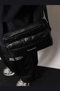 Balenciaga men’s black leather crossbody bag with sleek quilted design and subtle brand logo on the front