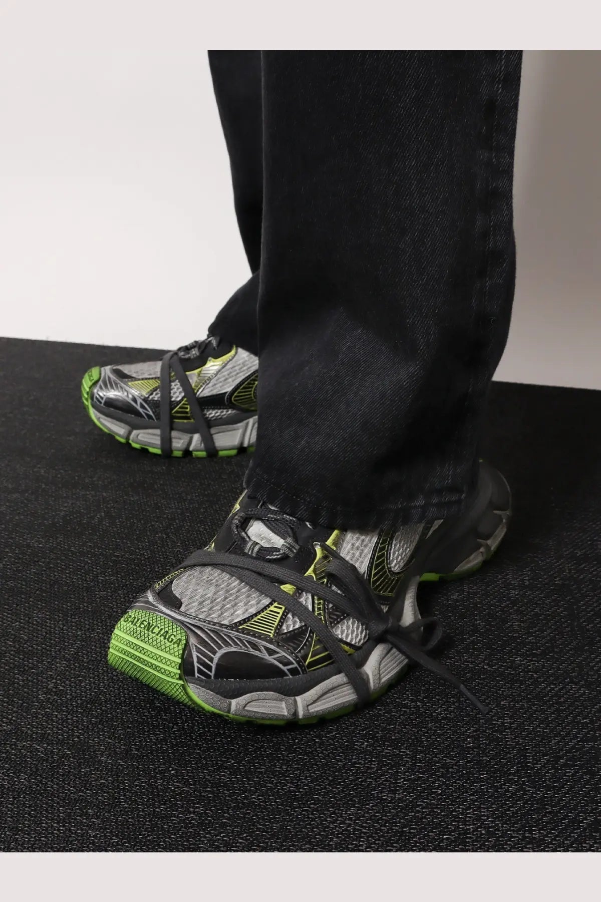Balenciaga men’s black and neon green triple s sneakers with mesh upper rubber sole and distinctive lacing system