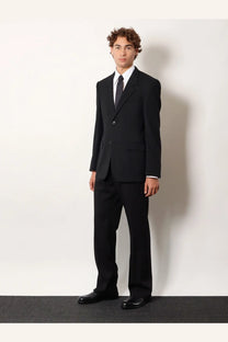 Balenciaga men’s black tailored wool blazer with single-button jacket and matching trousers styled formal with white shirt and tie