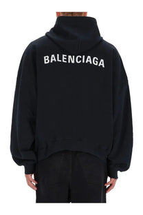 Balenciaga men’s black hoodie made of cotton with bold white lettering on the back for casual wear