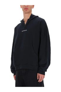 Balenciaga men’s black sweatshirt hoodie with minimalist white logo and oversized relaxed fit for casual wear