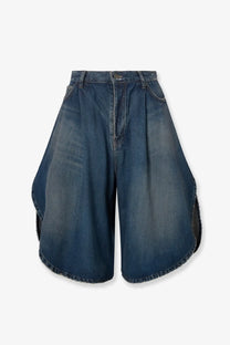Balenciaga women’s cotton bermuda shorts in medium blue wash with high waist flared asymmetrical cut and raw hem