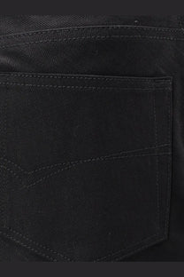 Balenciaga women’s black cotton midi skirt showing back side with subtle stitching on black denim jeans pocket