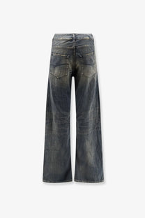 Balenciaga women’s curved waist dark-wash denim jeans in blue with wide-leg cut and faded distressed details