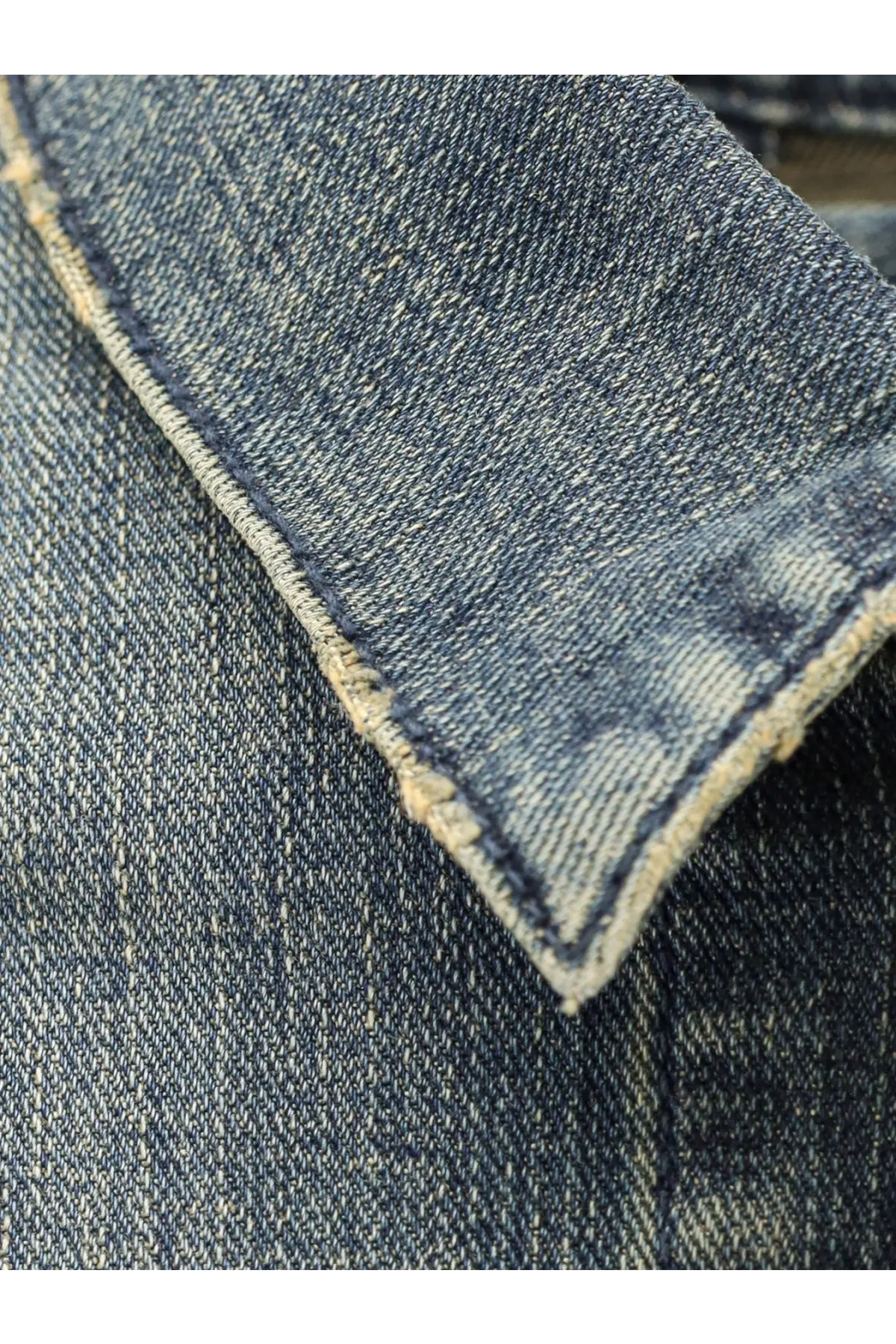 Balenciaga women’s blue denim jacket collar with worn frayed edges and visible stitching detail