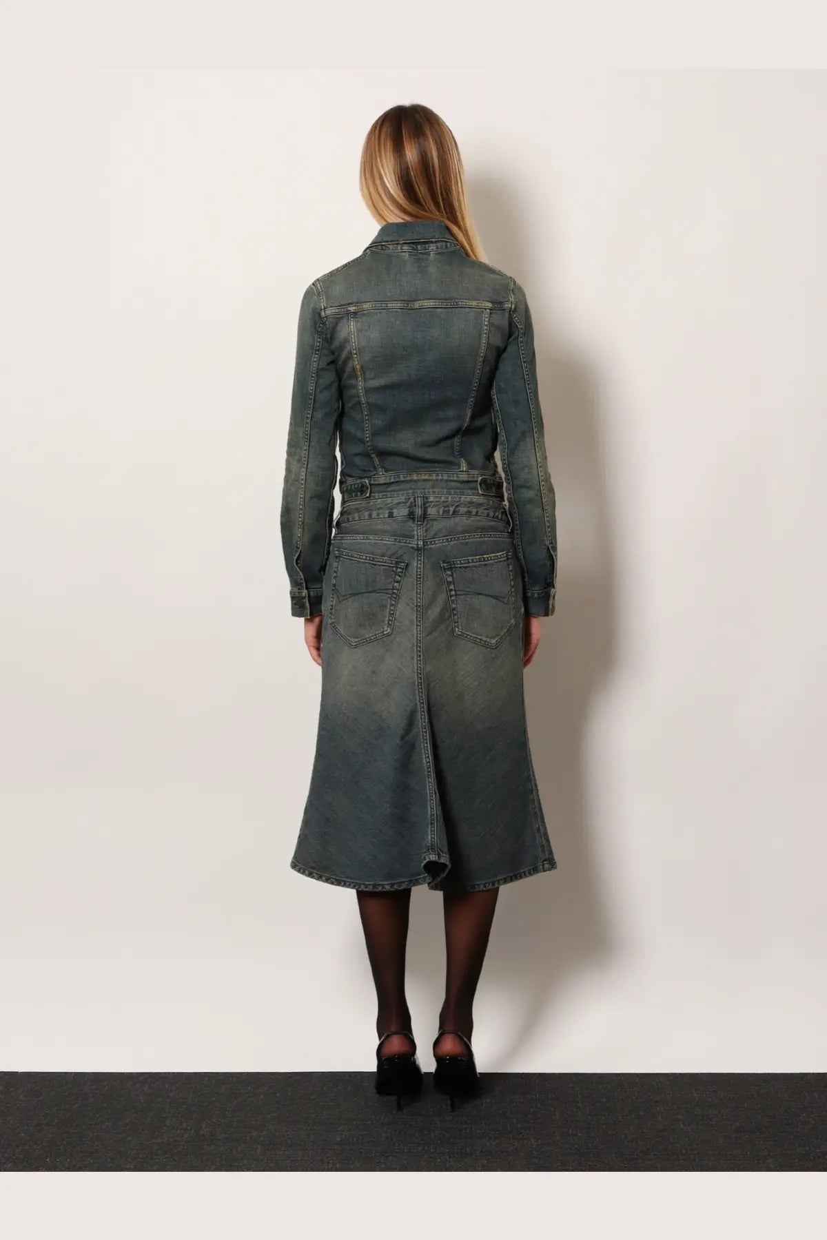 Balenciaga women’s dark gray denim jacket with belted waist and flared skirt-like hem shown from back
