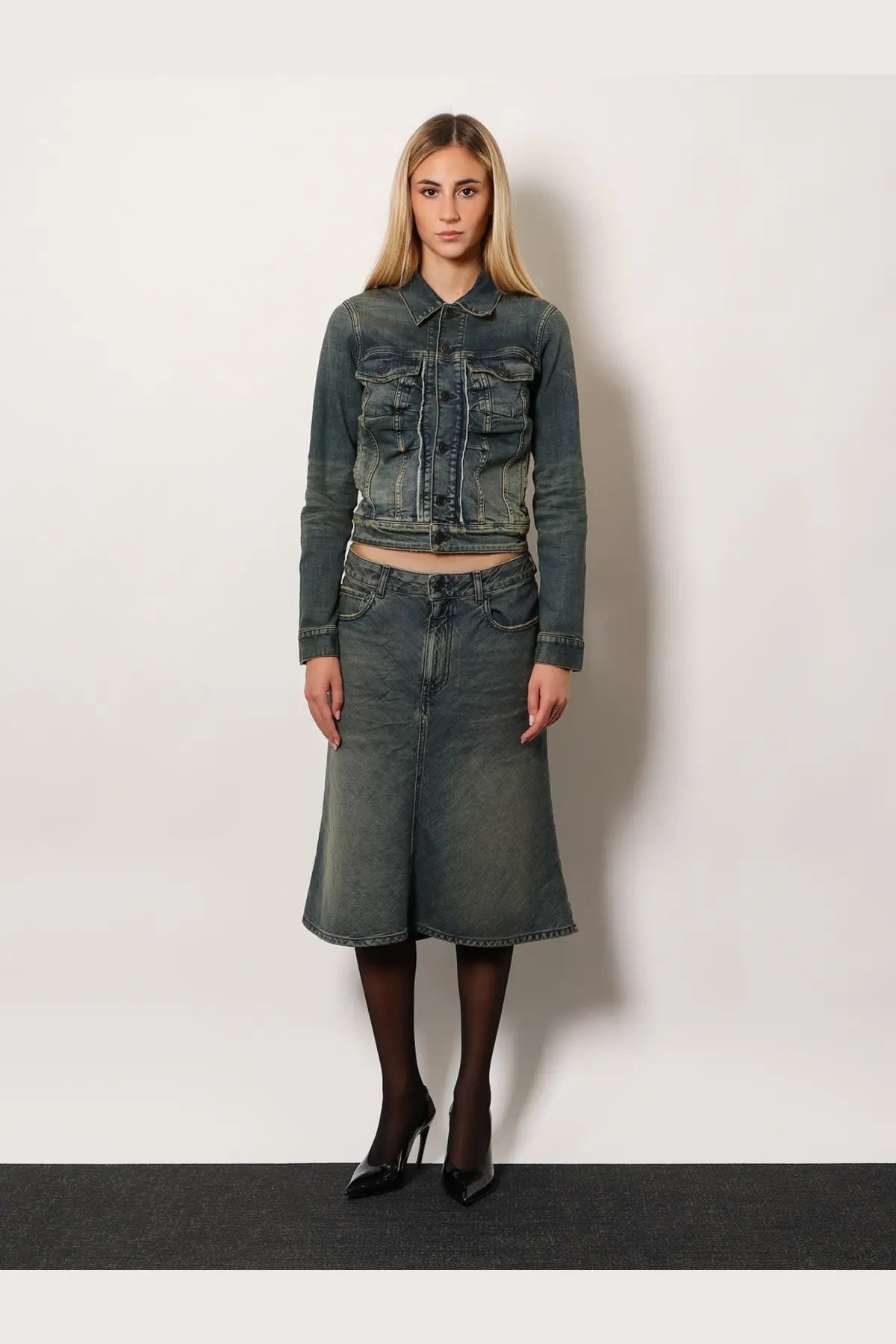 A dark-wash denim jacket with cropped fit and multiple front pockets paired with a balenciaga denim midi skirt blue