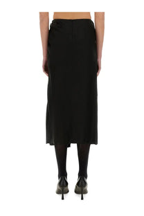 Balenciaga women’s draped black satin midi skirt with subtle sheen and central back zipper shown from the back