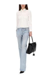 Black leather handbag with structured shape and top handle paired with balenciaga women’s city blue pants