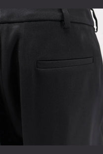 Balenciaga women’s slim tailored black wool trousers with subtle pleat and matching belt loop in textured fabric