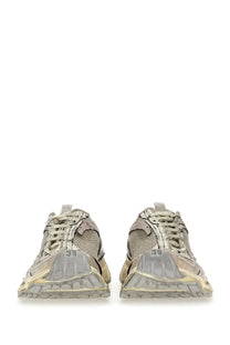 A pair of distressed beige and gray balenciaga women’s stapler sneakers with chunky soles