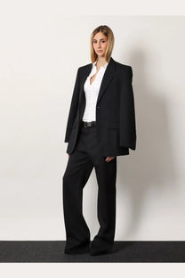 Black tailored blazer with notched lapels and matching wide-leg Balenciaga women’s stretch wool trousers in black
