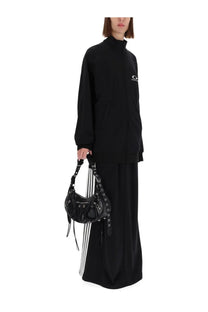 Black leather balenciaga speedy bag with silver hardware and fringed straps featured with balenciaga women’s sweatshirt black