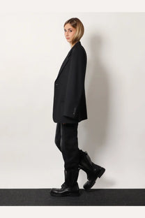 Black oversized blazer with structured silhouette and subtle button detailing from balenciaga women’s tailored standard line