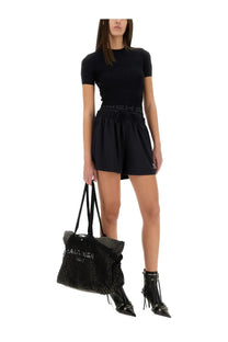 Black textured tote bag with embossed balenciaga logo and drawstring closure for versatile everyday use