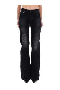 Balenciaga women’s black denim flare jeans with distressed detailing on the thighs and wide leg design