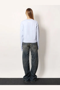 Balenciaga women’s wool and cotton blend light blue long-sleeved sweater showing the back with a subtle white logo