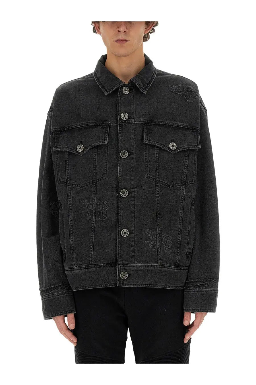 Balmain men’s black distressed denim jacket featuring silver-toned buttons and patchwork detailing