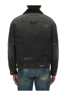 Balmain men’s destroyed black denim jacket with distressed details, plush shearling collar, and Balmain Paris waistband label