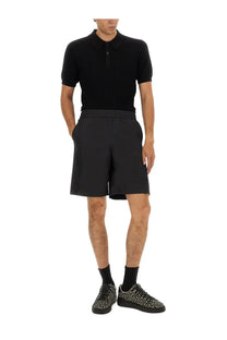 Balmain men’s knitted polo black short-sleeved shirt with classic collar and buttoned placket in cotton blend