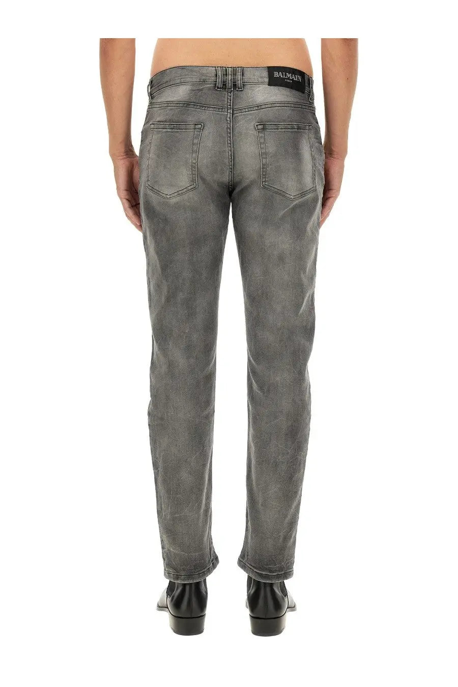 Balmain men’s regular fit grey distressed denim jeans with subtle pattern and black waistband label visible from front
