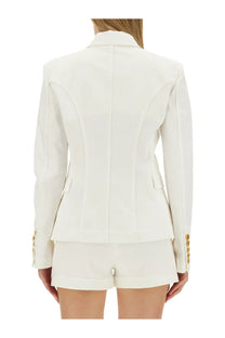 Balmain women’s six button jacket white featuring a sleek white blazer with gold-tone buttons and tailored seams