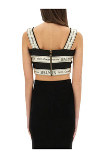 Balmain women’s black crop top with white logo bands and central gold zipper for stylish casual wear