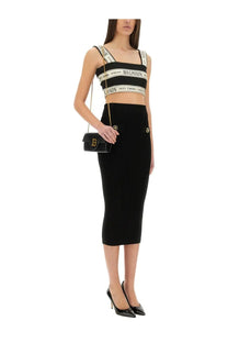 Black ribbed midi skirt with gold tone button details paired with balmain womens top short multicolor