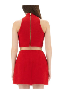 Back view of balmain women’s red wool crop top with textured fabric and gold zipper down the back