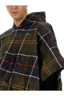 Barbour men’s poncho in dark green and black tartan with red white and brown stripes and a hooded design