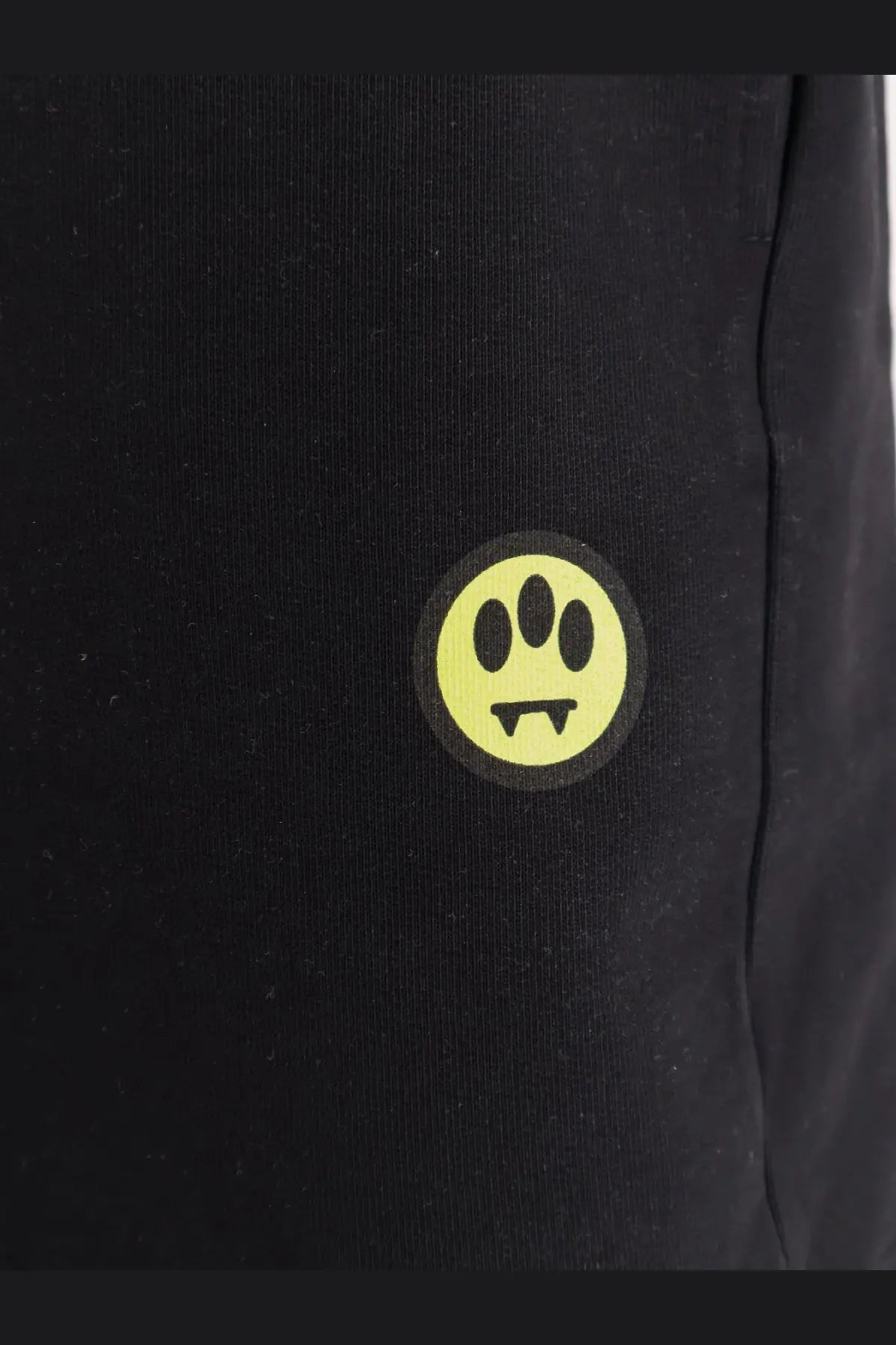 Barrow men’s cotton bermuda shorts black showing bright yellow circular logo with three oval eyes and fangs