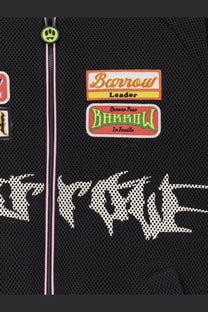 Barrow men’s black nylon and mesh bomber jacket with neon green skull zipper pull and colorful embroidered patches