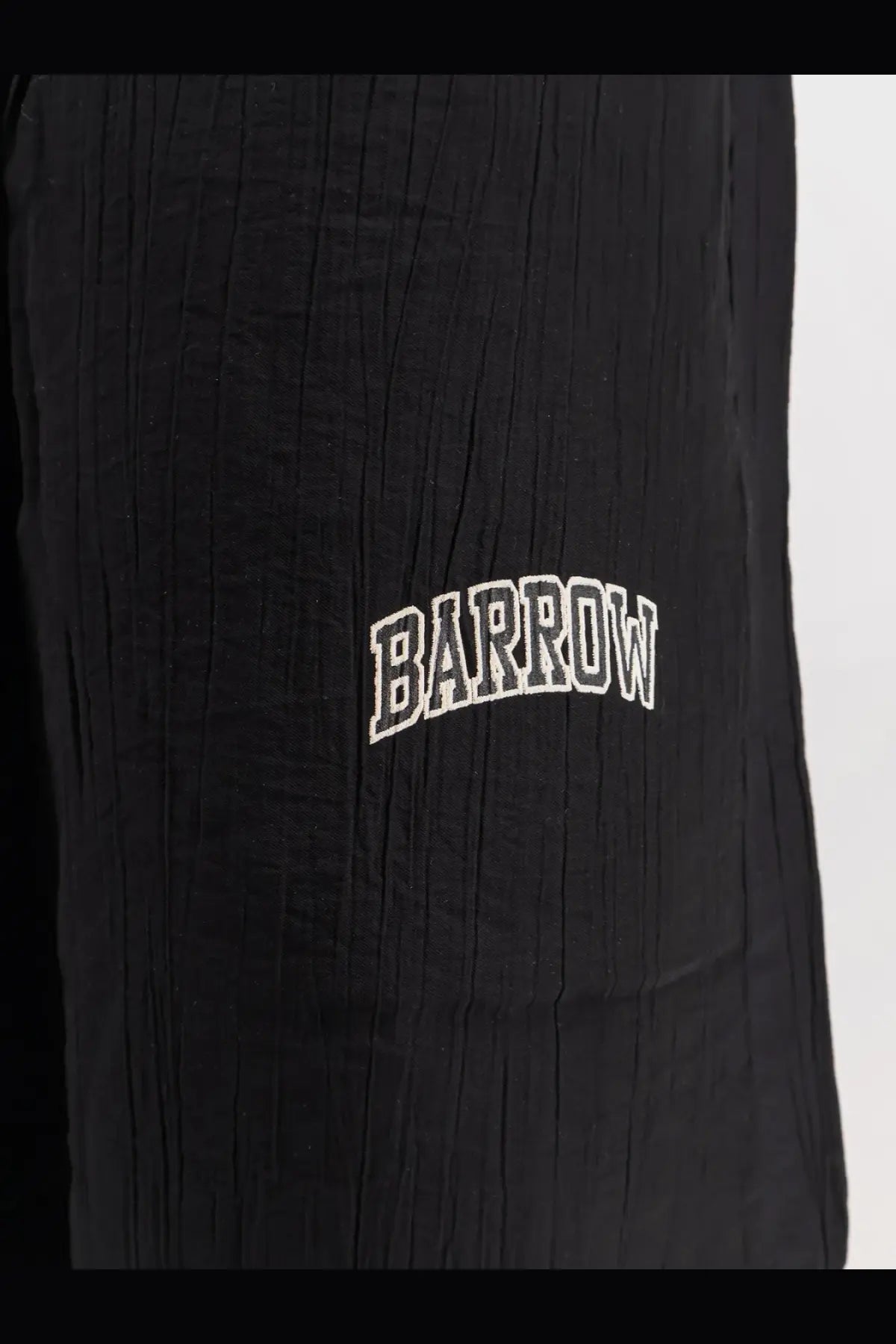 Black textured viscose blend bermuda shorts with white embroidered barrow logo in an arched design