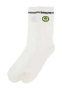 Barrow unisex white socks with neon green fanged smiley face and black horizontal stripes above the brand name